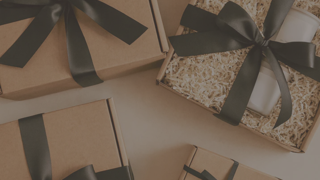 multiple gifts boxes laid out on a table in the branding bow