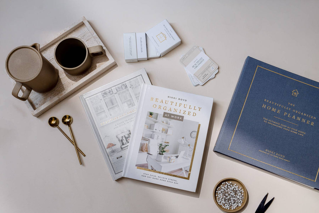 Home organization books and a mug on a light surface