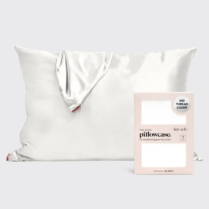 A white satin pillowcase displayed next to its packaging which reads &
