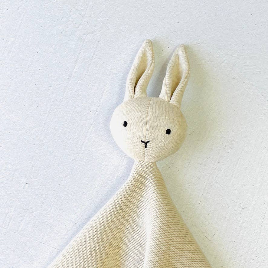 Beige plush bunny toy on a white background