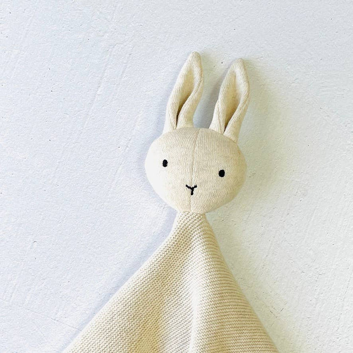 Beige plush bunny toy on a white background