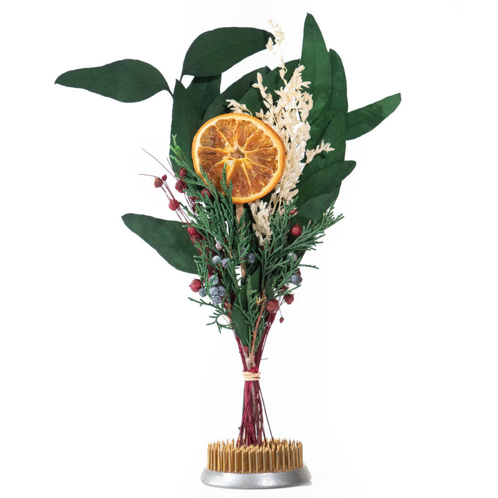 Bouquet of dried flowers with a dried orange slice on a white background