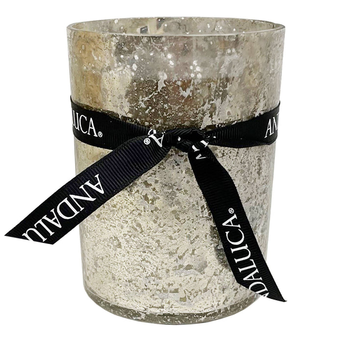 Decorative candle in a textured glass holder with a black ribbon featuring &