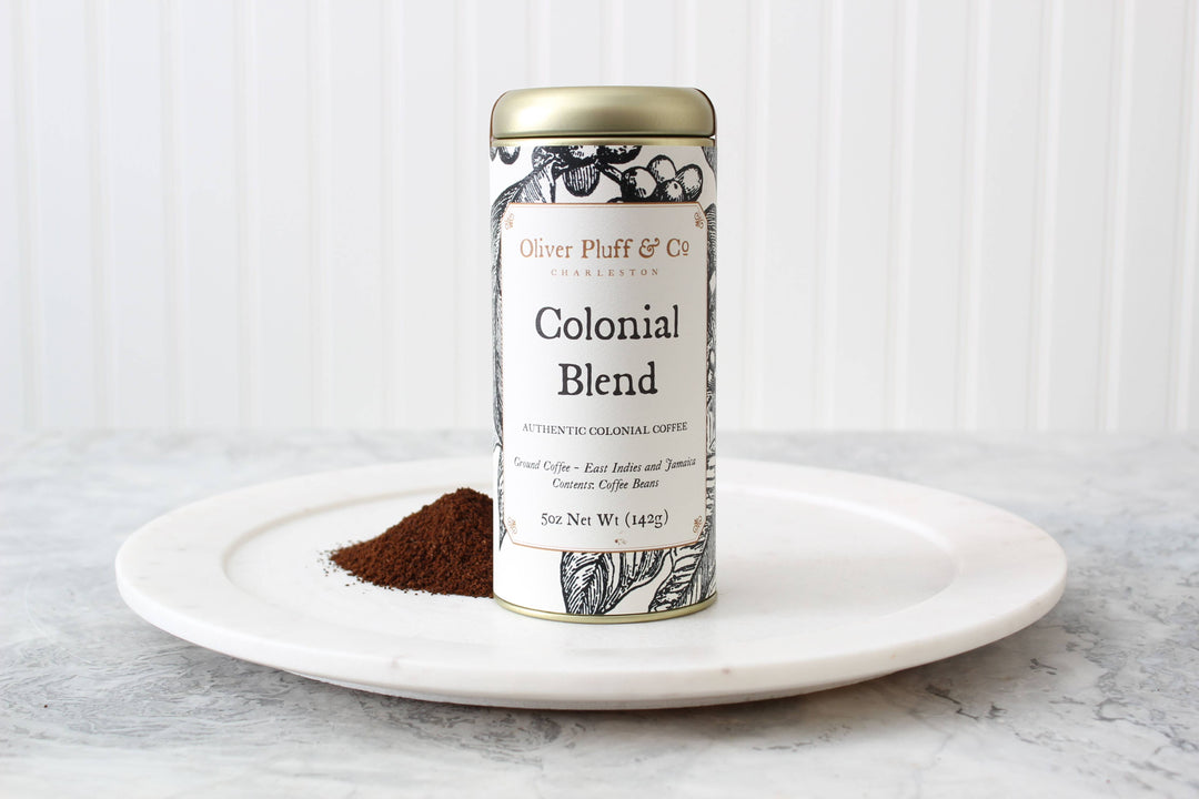 Canister of Colonial Blend coffee on a white plate with a white background