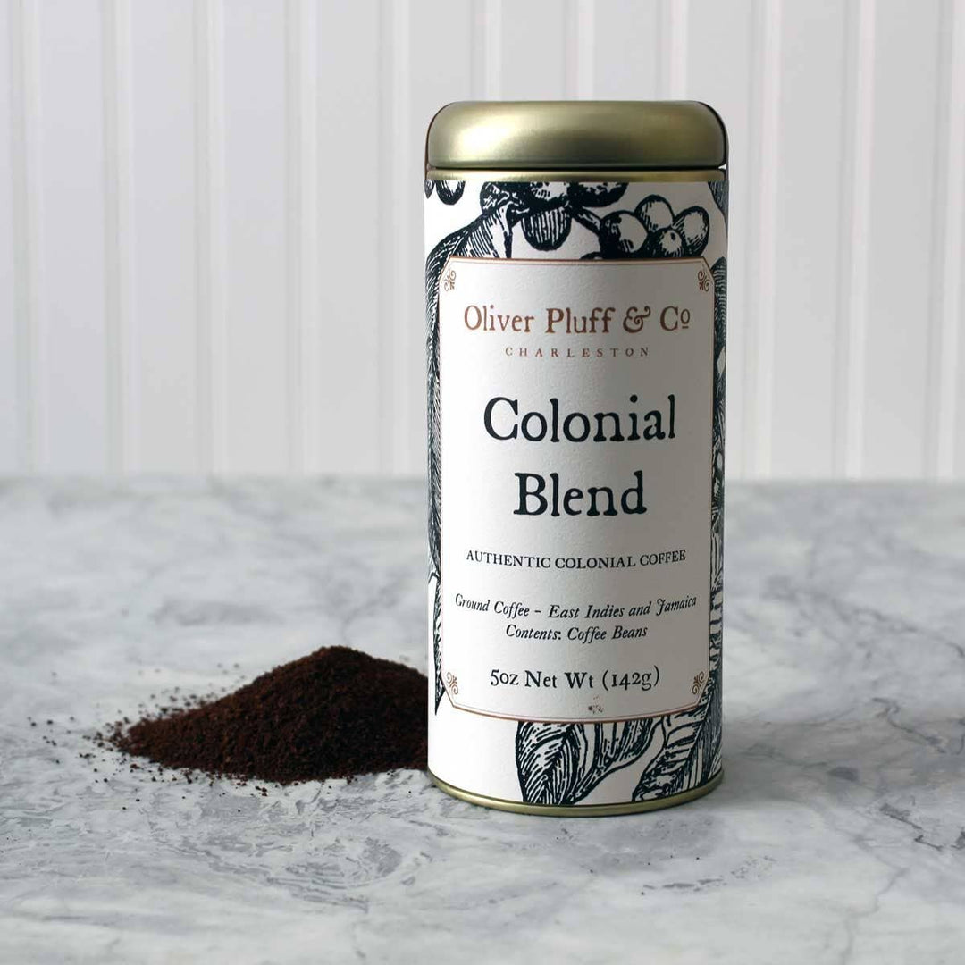 Canister of Oliver Pluff &amp; Co Colonial Blend coffee on a marble surface with a white background