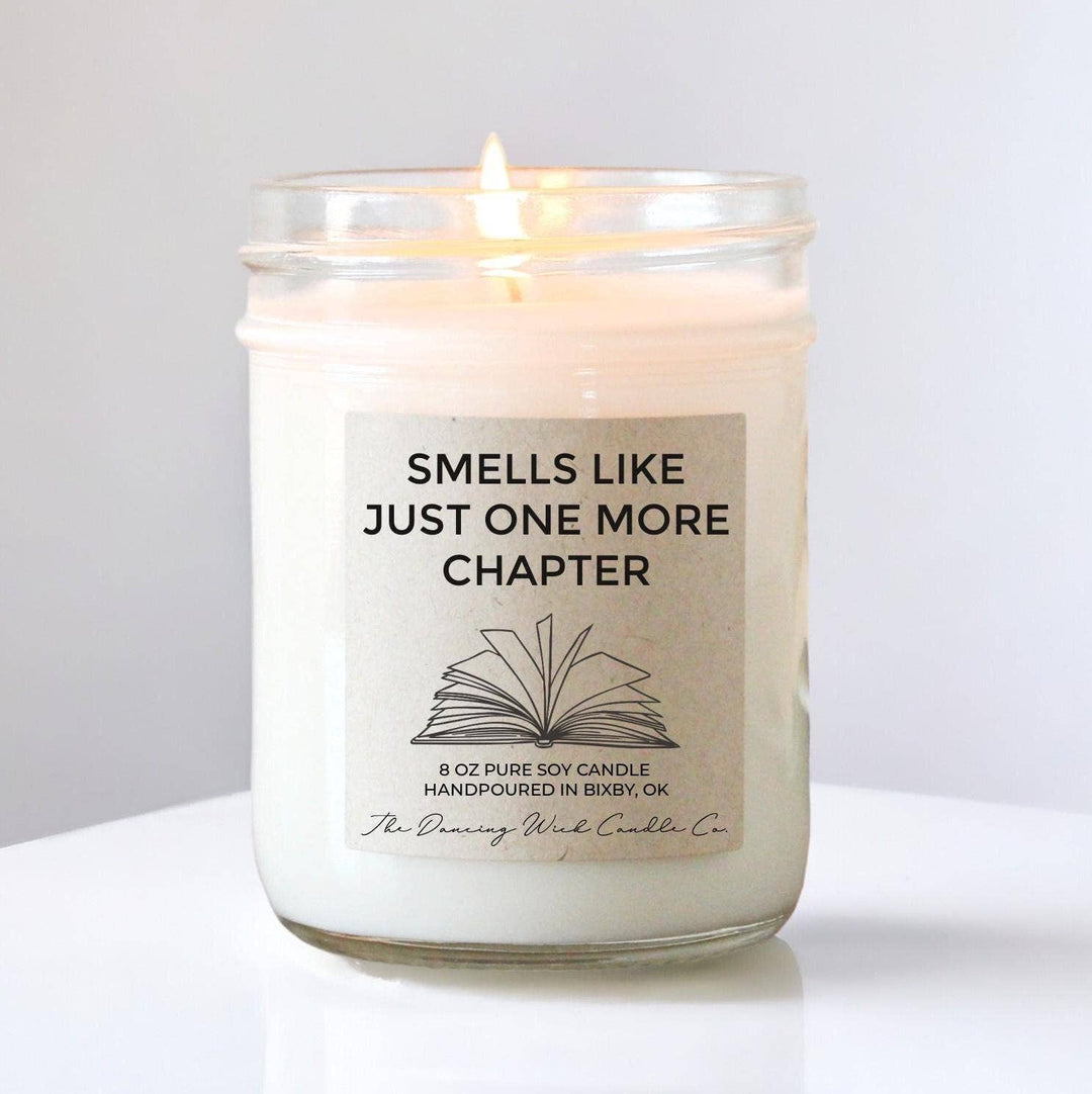 Candle with a label reading 'Smells Like Just One More Chapter' on a white background