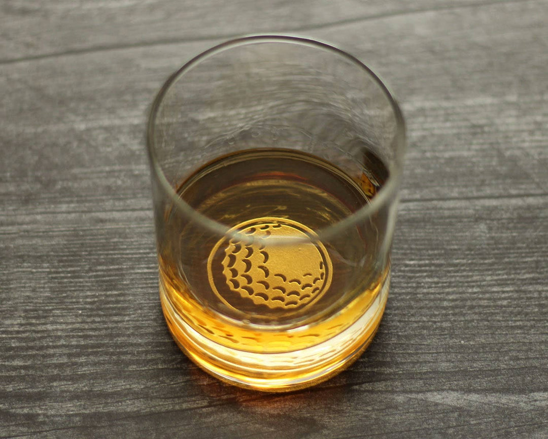 Liquor glass with a golf ball design on a wooden surface