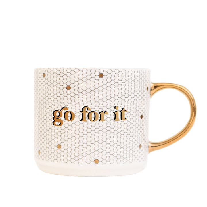 A white ceramic coffee mug with a honeycomb design and the phrase &