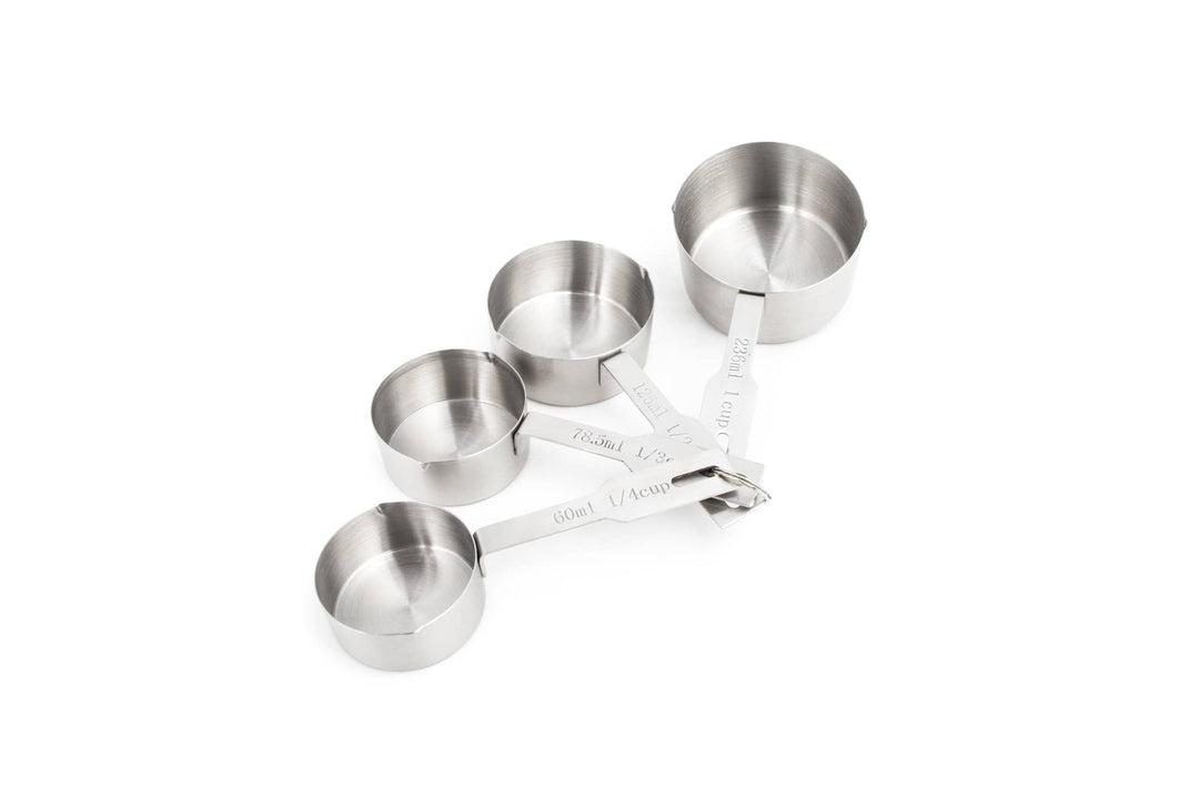 A set of four stainless steel measuring cups in different sizes, fastened together with a connector ring.