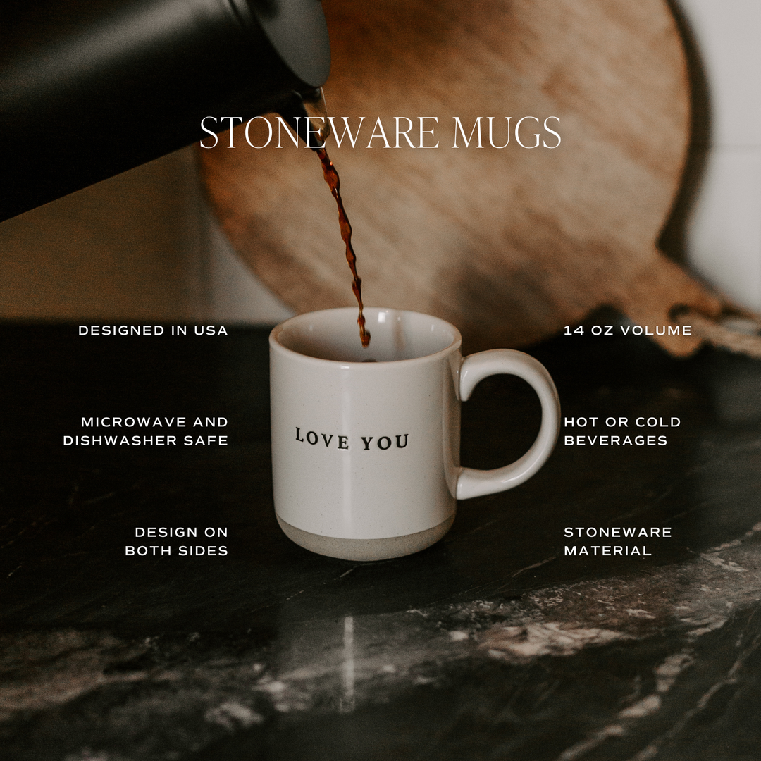 Stoneware mug being filled with coffee on a marble surface.