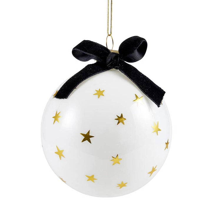 White ornament with gold stars and a black ribbon on a white background