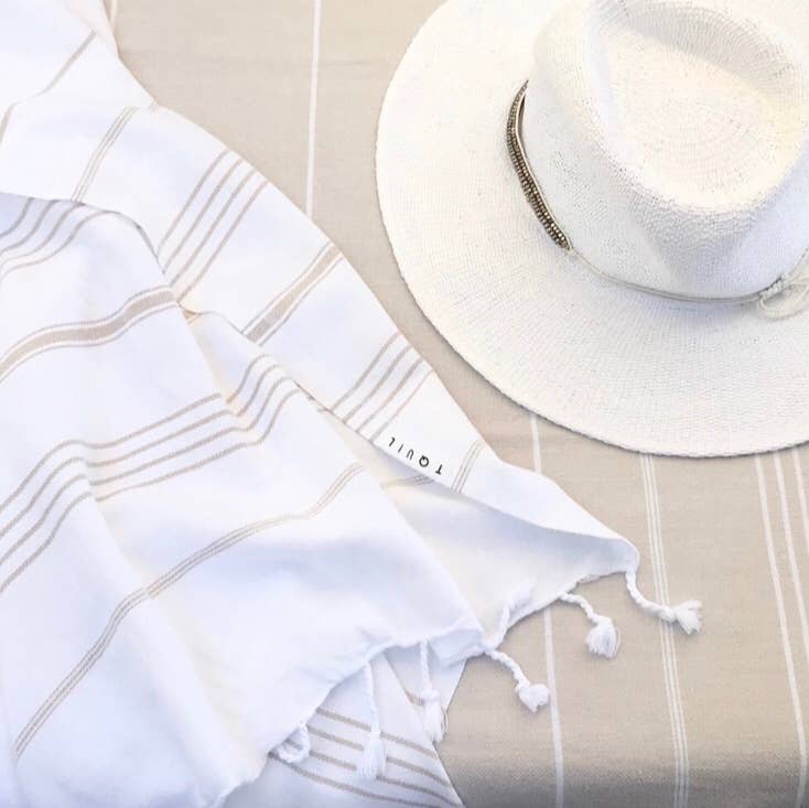 White sun hat and towel with &