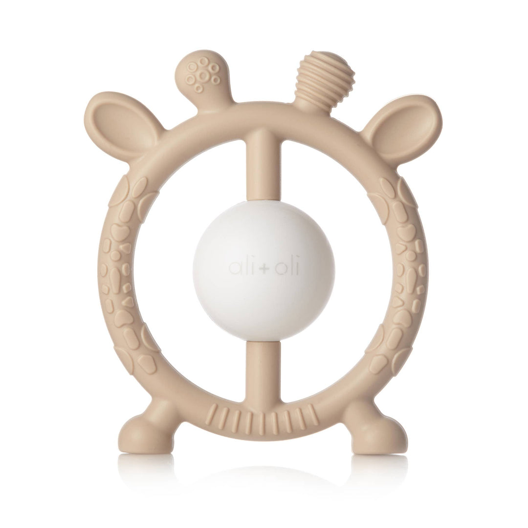 Beige baby teether with a white ball in the center on a white background