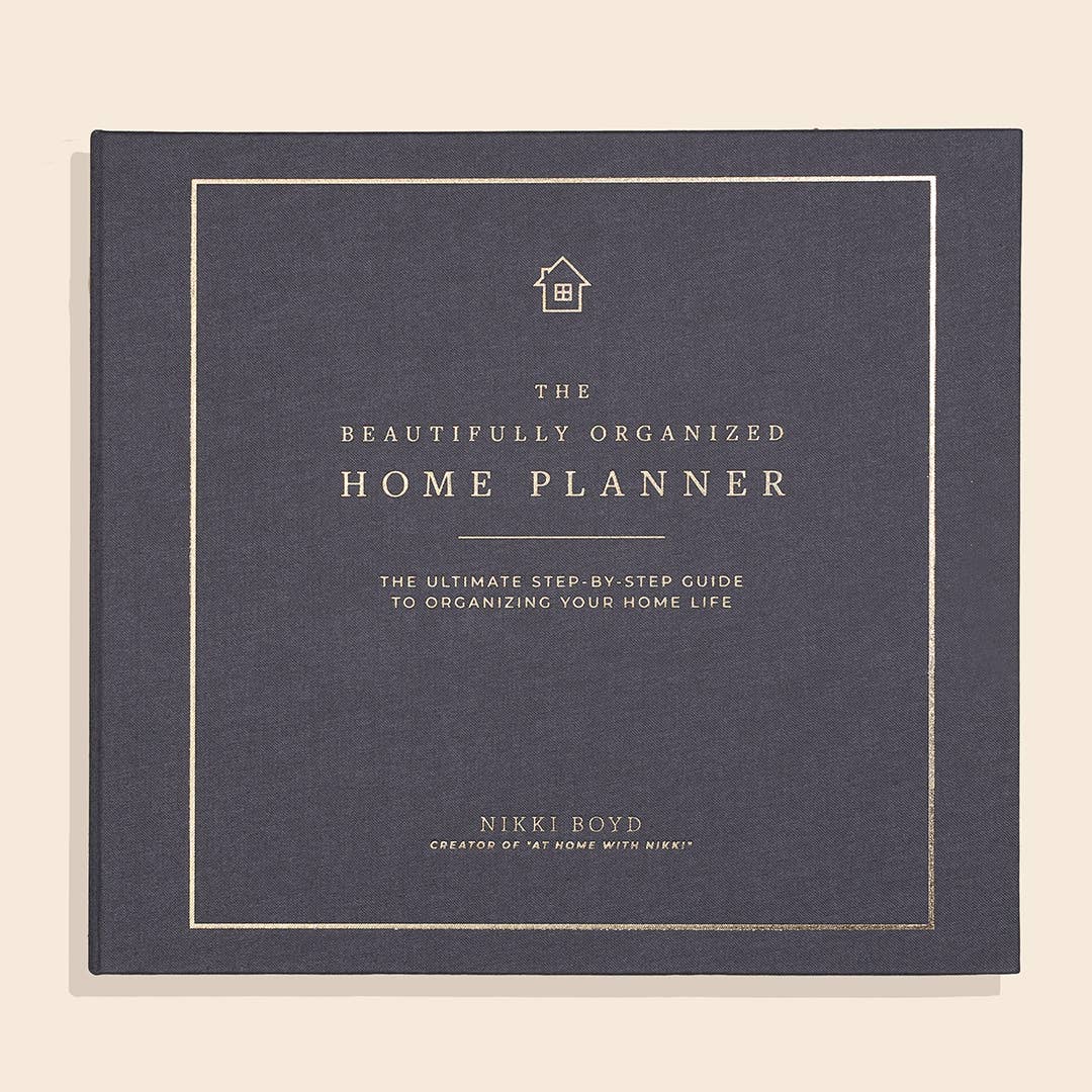 Book titled 'The Beautifully Organized Home Planner' on a beige background