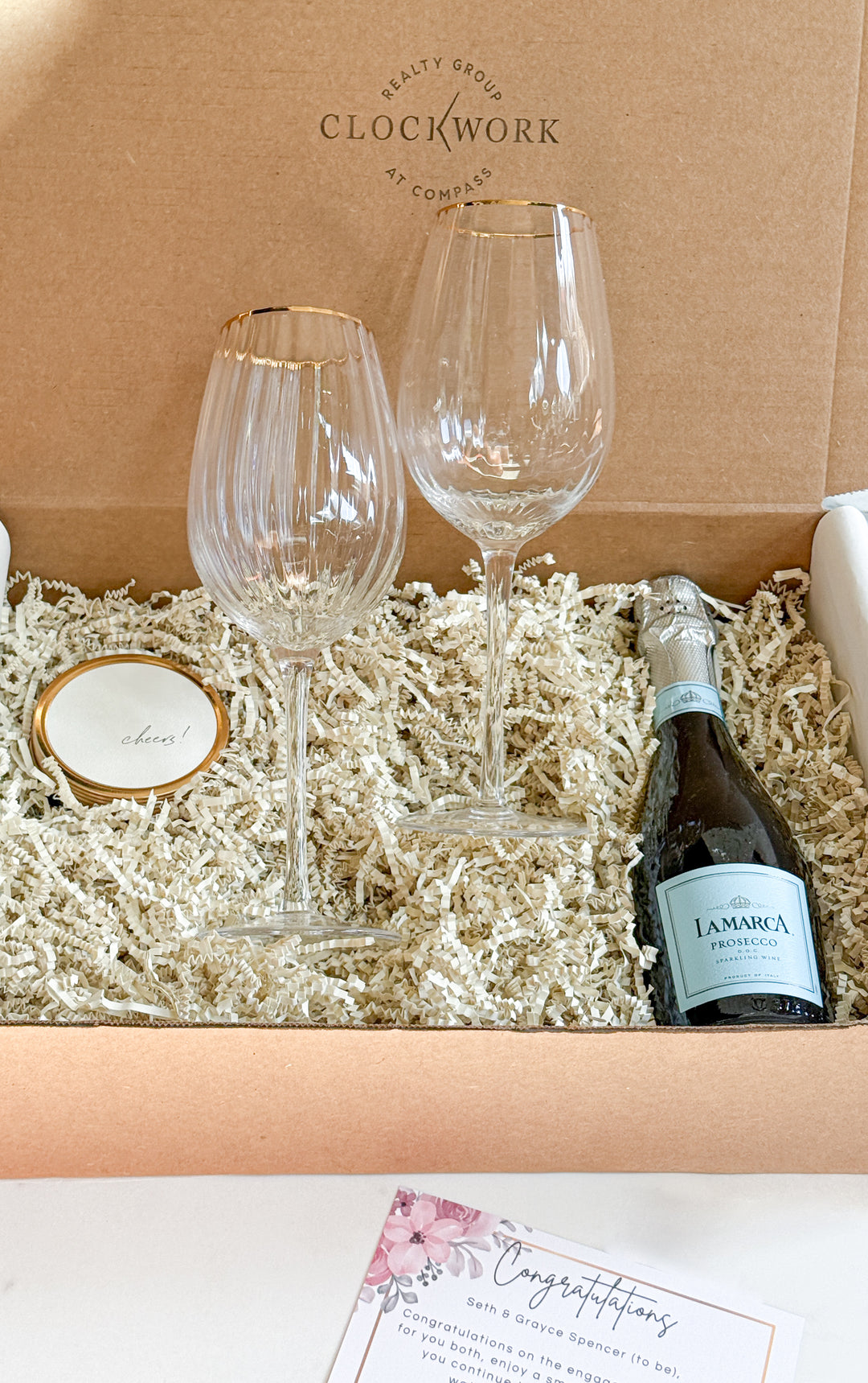 Gift set with wine glasses, a round tin candle and a bottle of wine in a &