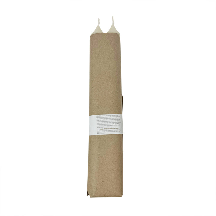 Tall candlesticks wrapped in brown paper with a white label.
