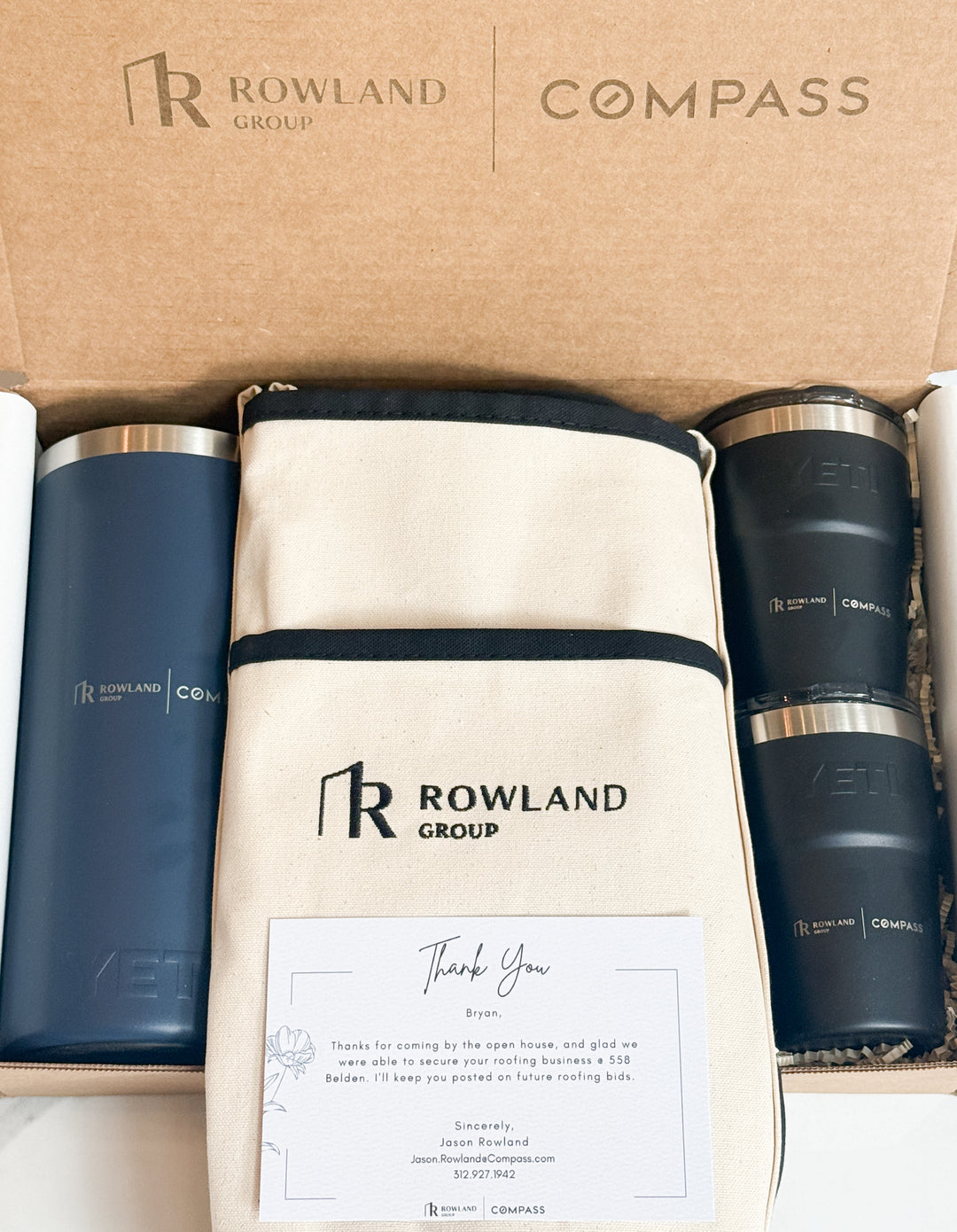 Rowland Group branded tumblers and pouch in a box with &