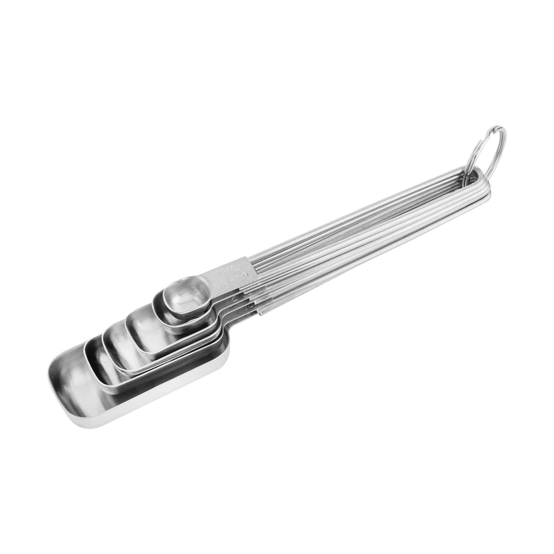 All sizes of stainless steel measuring spoons tacked in each other. 