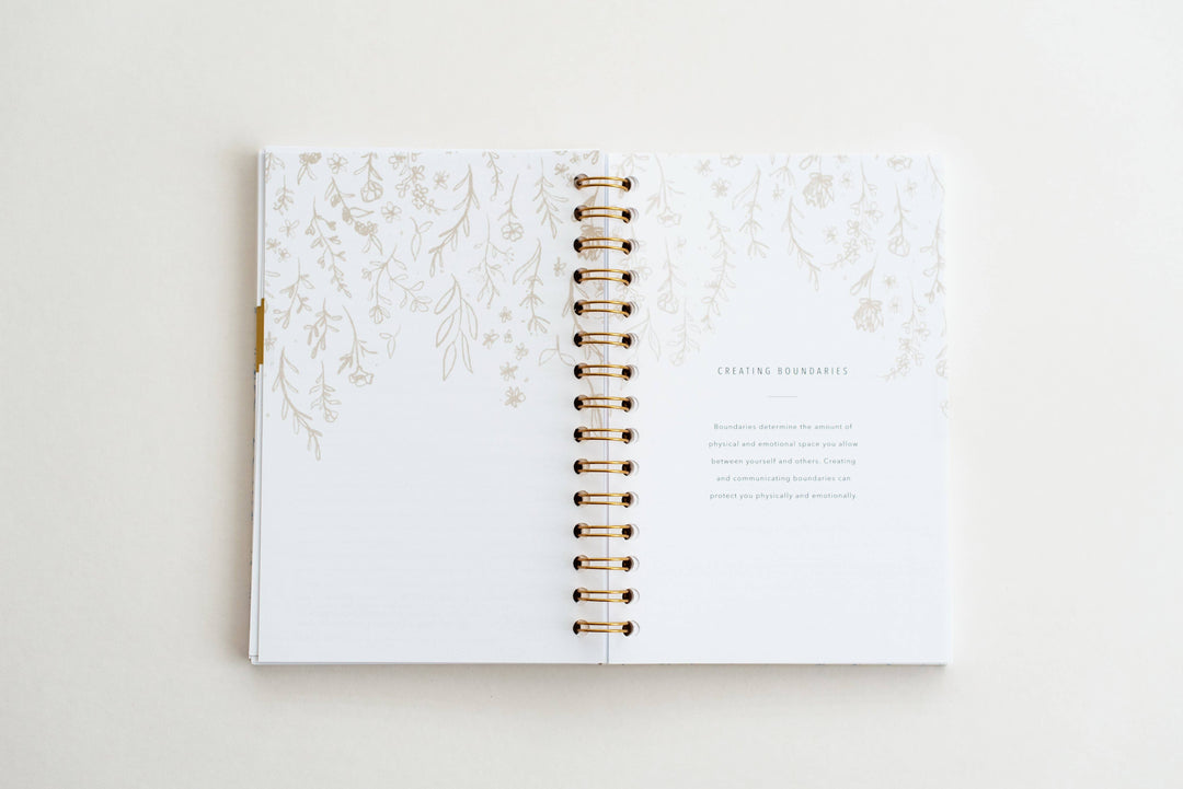 Open planner with floral design on a white background