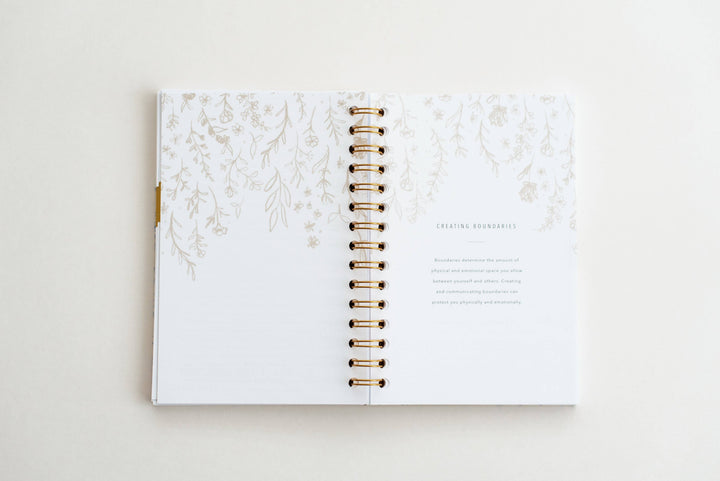 Open planner with floral design on a white background