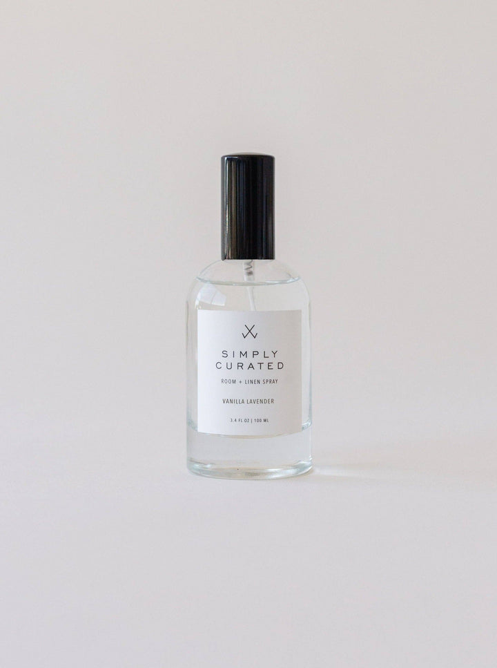 Clear glass bottle with black cap labeled &