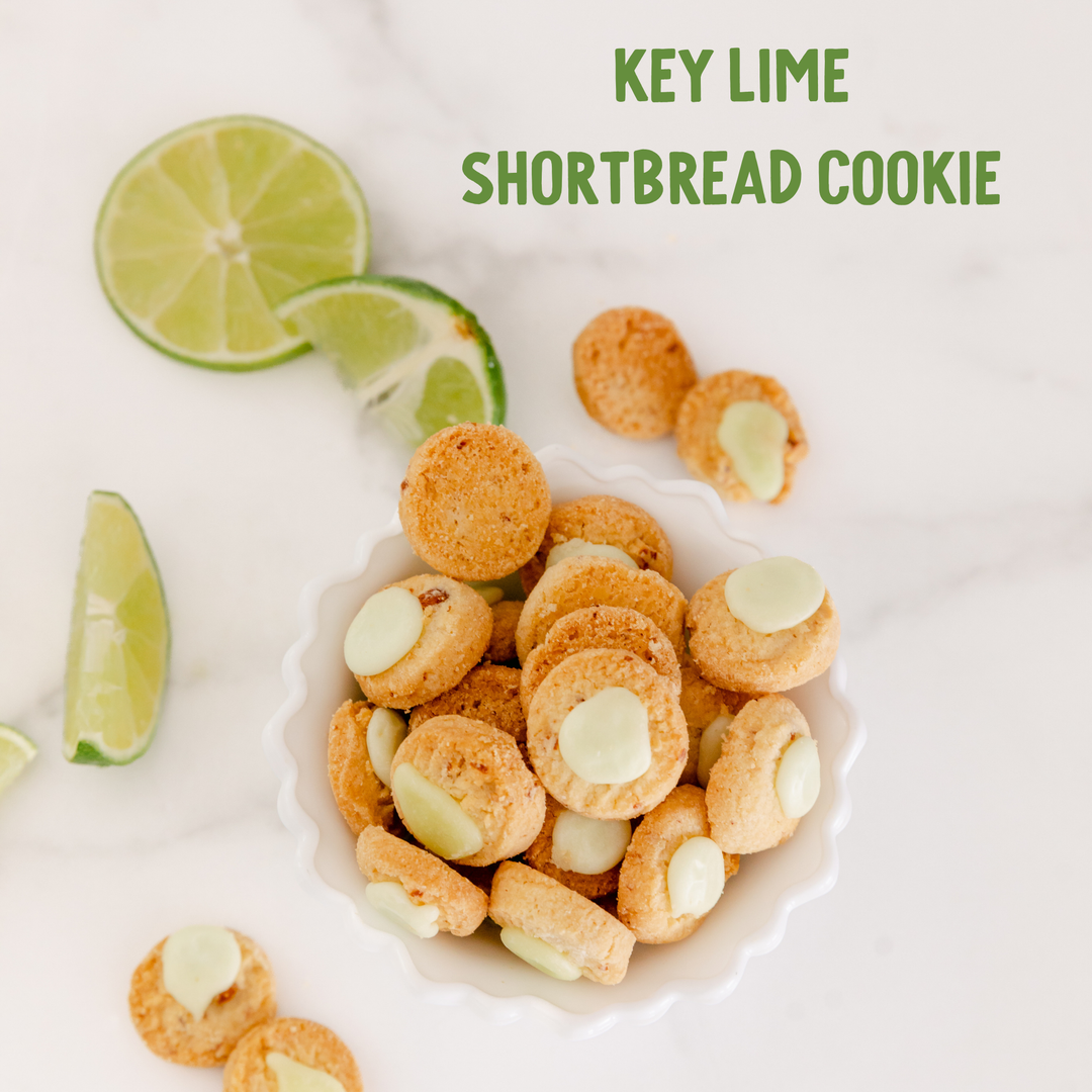 Key lime shortbread cookies with lime wedges on a white background