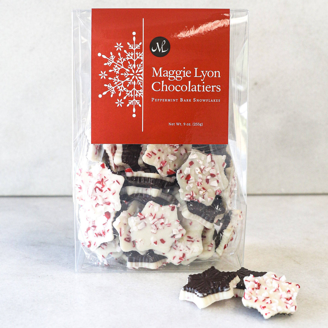 Packaged peppermint bark snowflakes from Maggie Lyon Chocolatiers on a white background