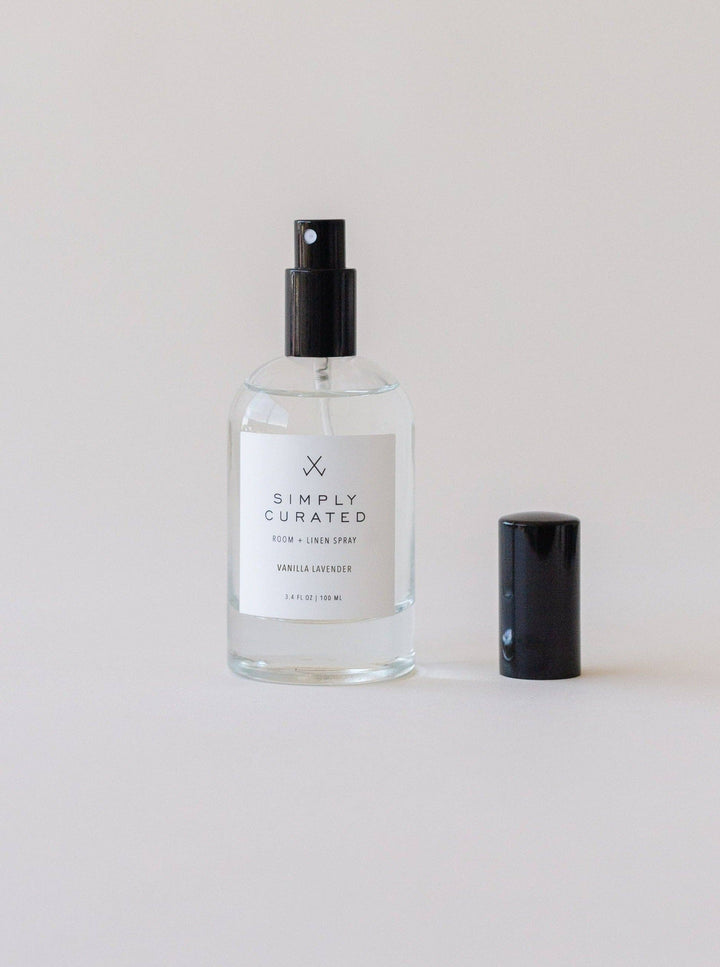 Clear spray bottle with black cap labeled &