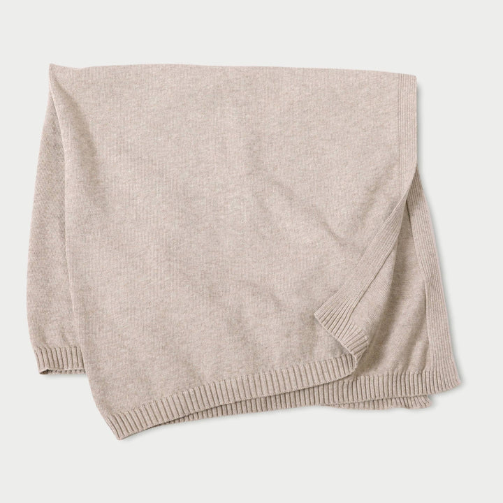 Beige knitted blanket on a white background