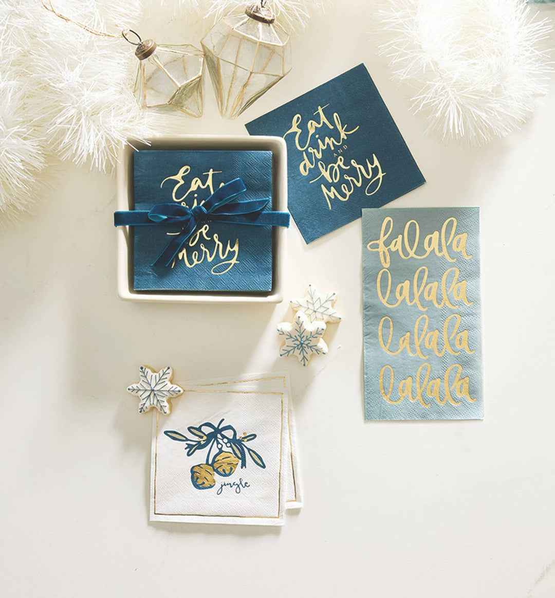 Holiday-themed napkins with napkin holders and decorative items on a white background.