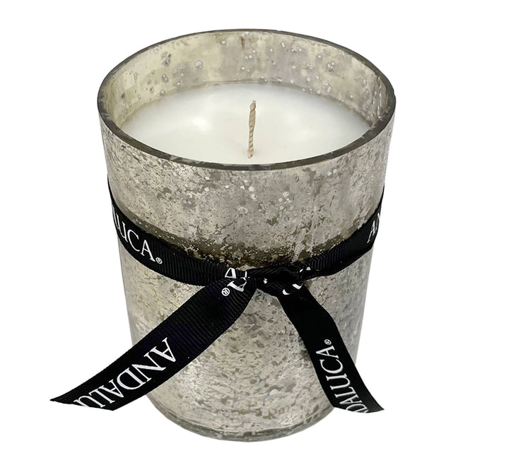 Candle in a textured glass holder with a black ribbon featuring &