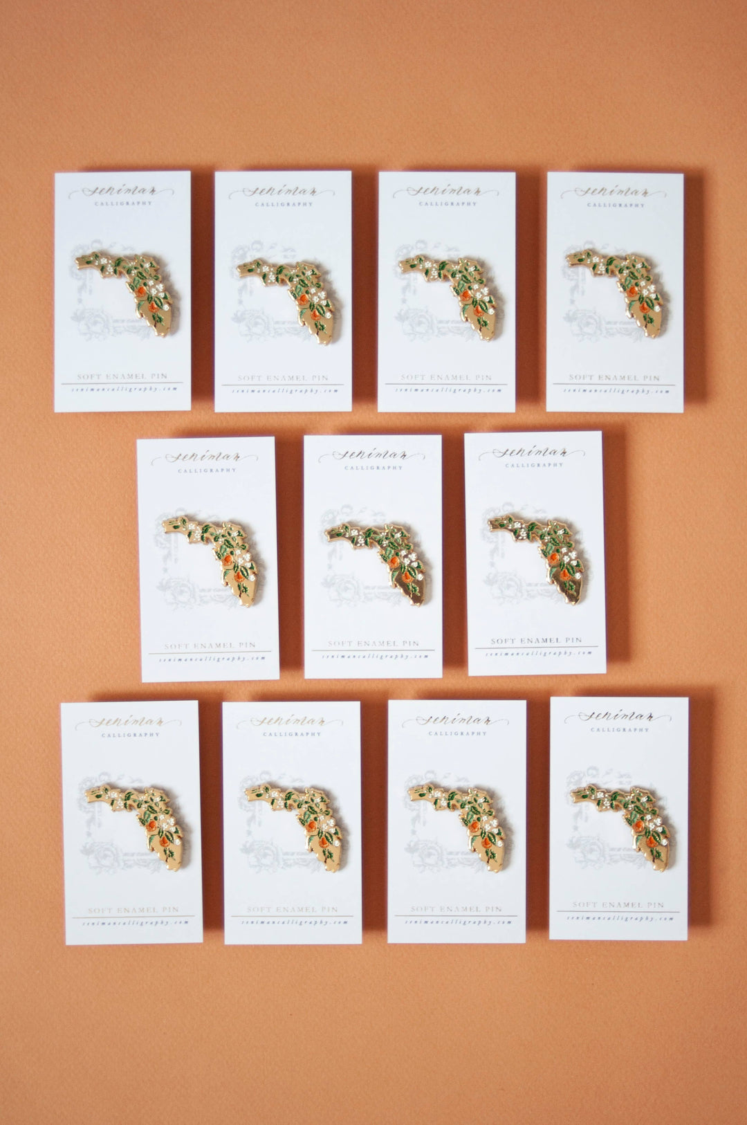 Set of decorative cards with floral designed pins on a brown background