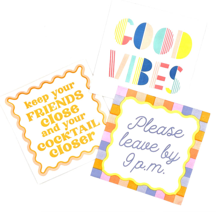 Three colorful napkins with humorous texts on a white background. One features the text &