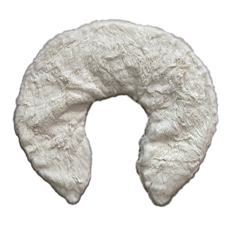 White fur neck pillow shaped like a crescent moon