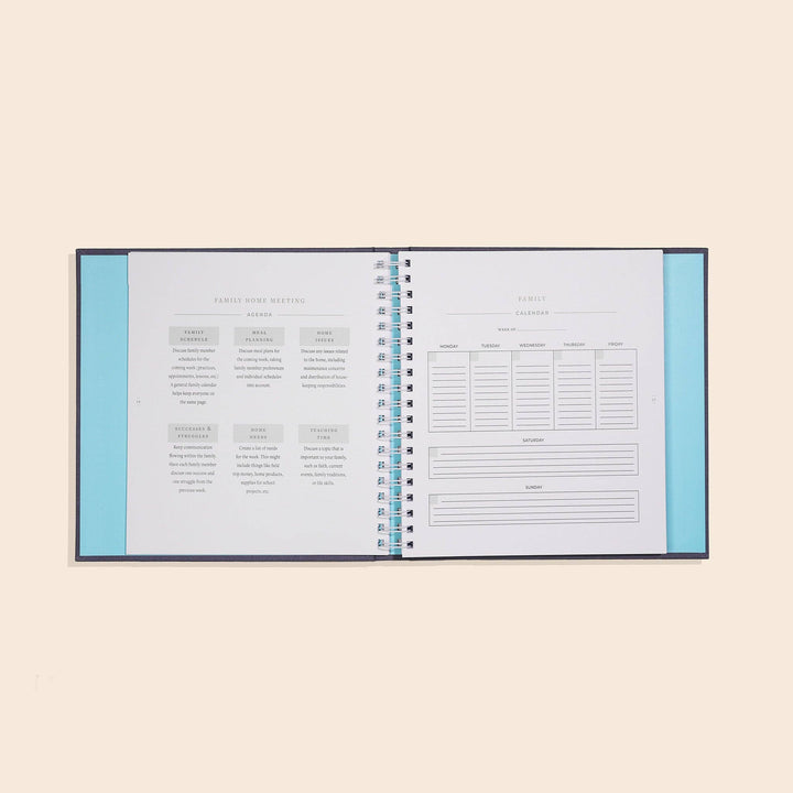 Open planner with blue interior on a beige background