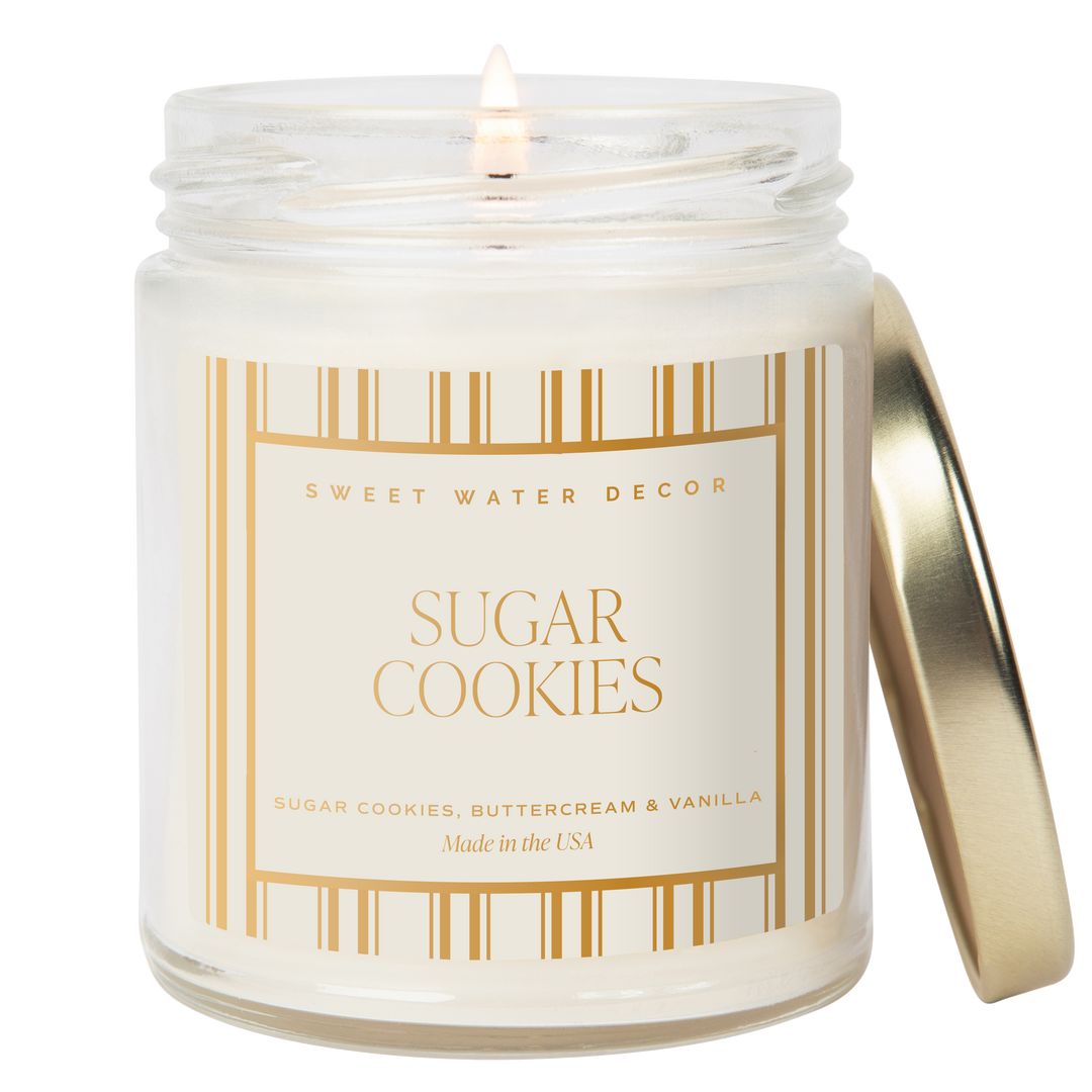 Candle in a glass jar with a gold lid and &