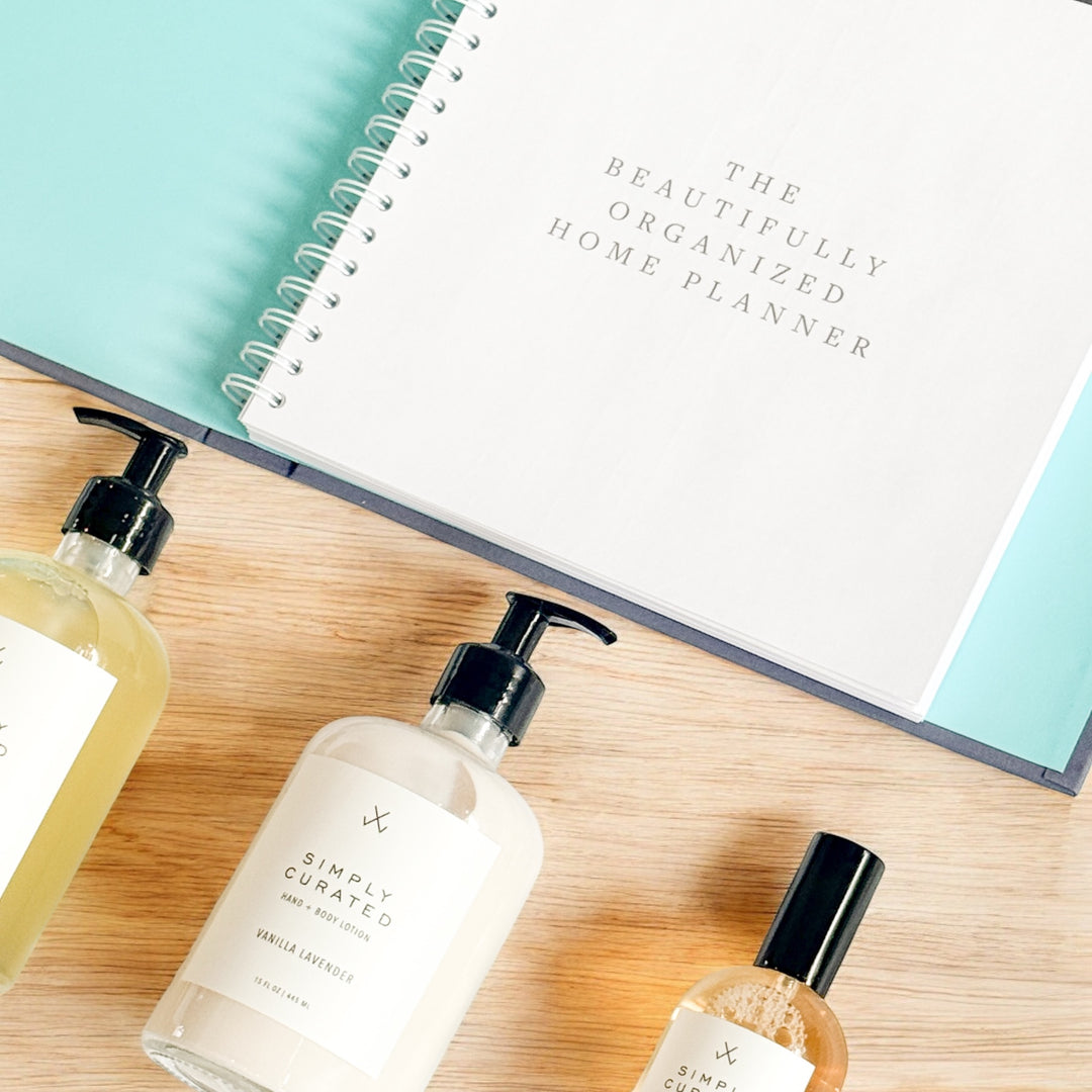 Close-up of The Beautifully Organized Home Planner paired with vanilla lavender hand wash, hand and body lotion, and room and linen spray, arranged as an elevated housewarming and realtor closing gift.