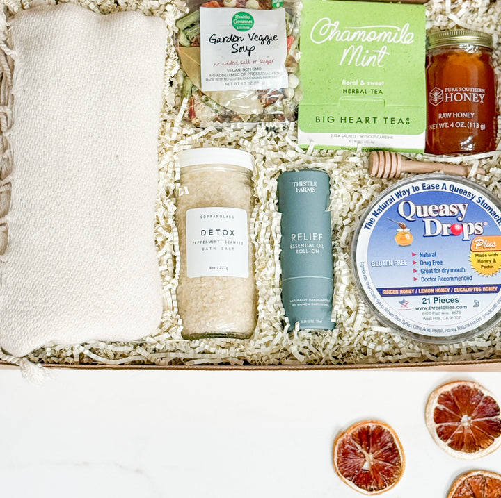 Assorted health and wellness products in a box with visible labels.