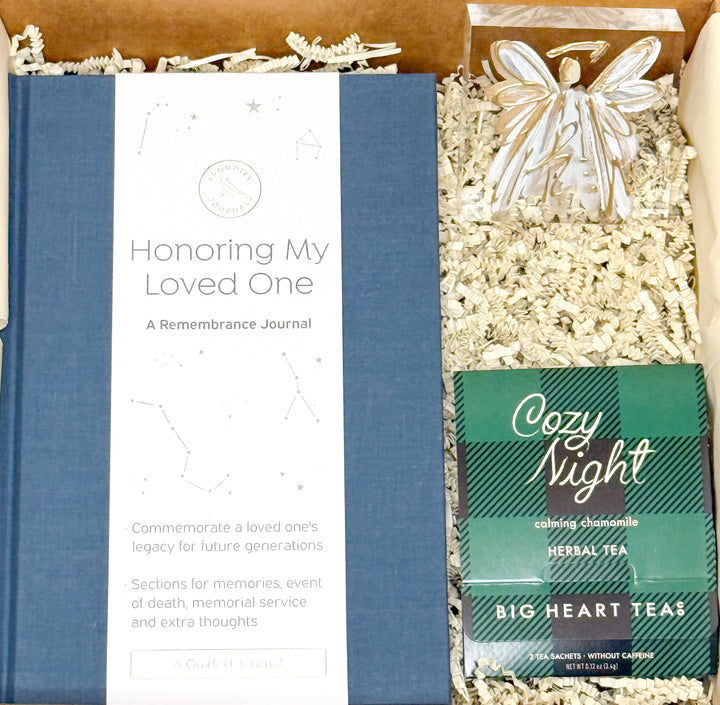 Memorial gift set with a journal, tea, and angel figurine.