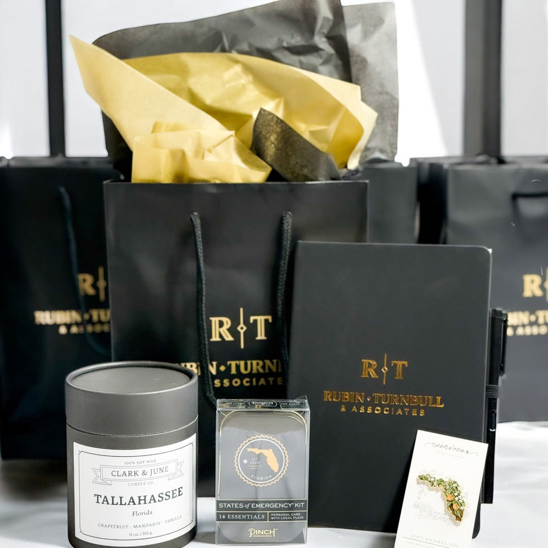 Collection of items including a black cylindrical candle, a Florida emergency kit, a &