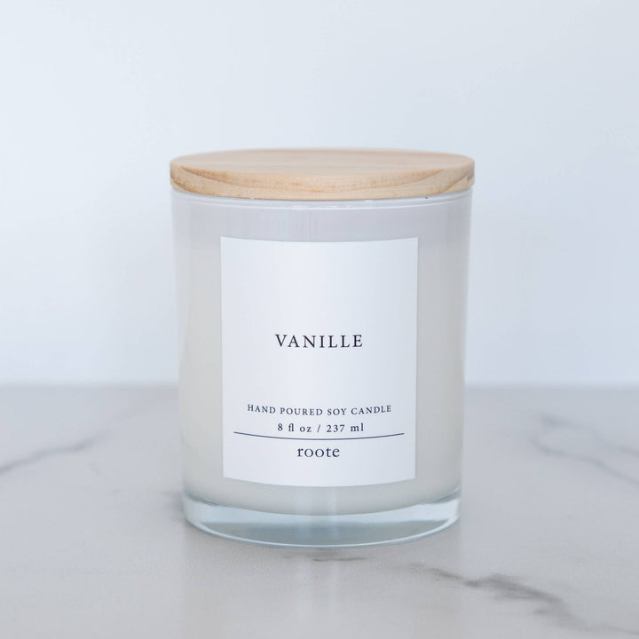 Candle with a wooden lid labeled &