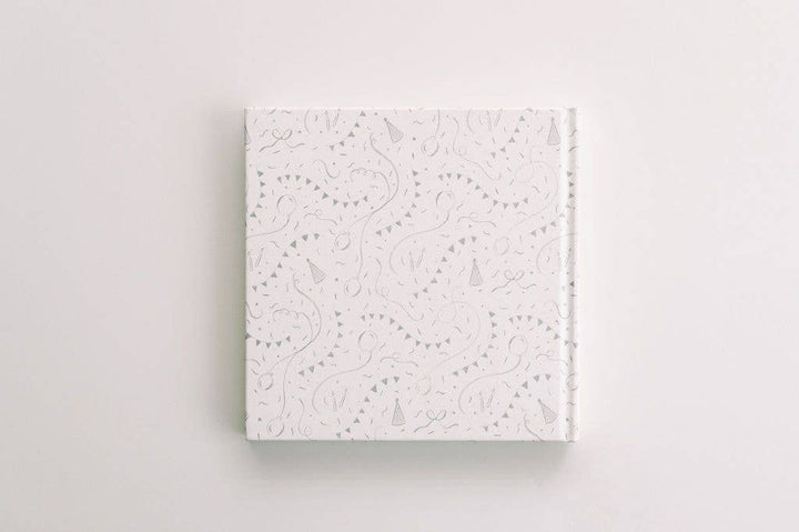 White textured square book on a light gray background