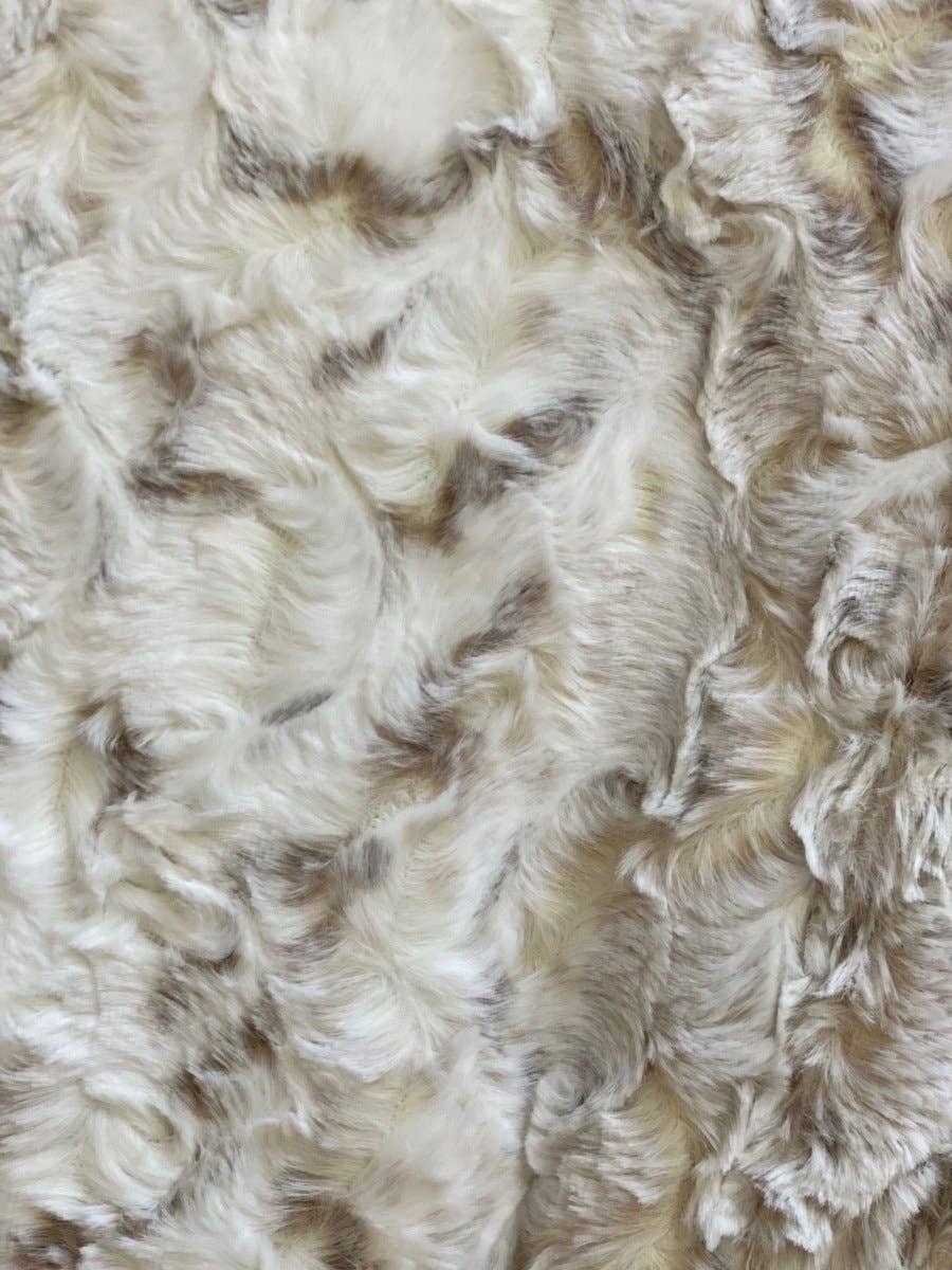 Close-up of fluffy white and brown throw blanket. 