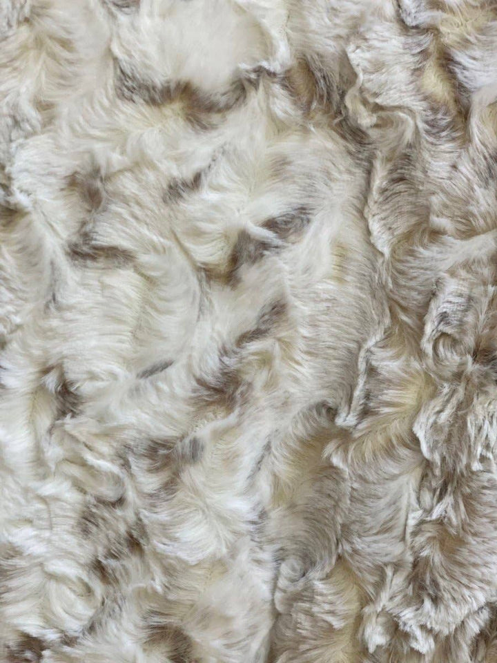 Close-up of fluffy white and brown throw blanket. 