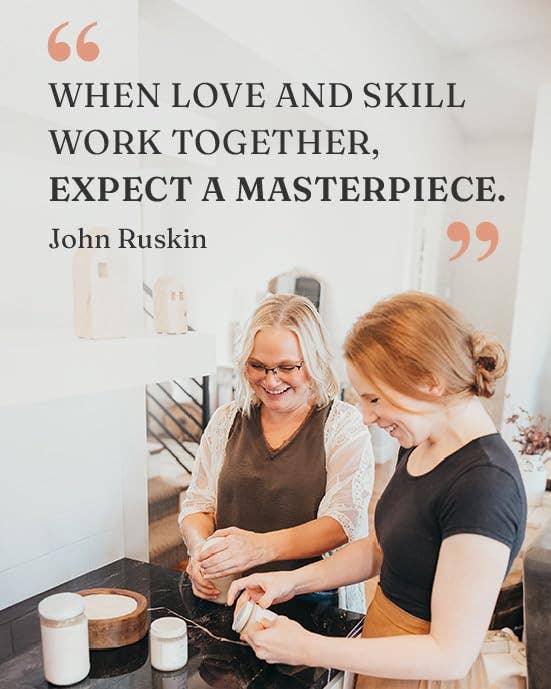 Two women working together in a kitchen with a quote by John Ruskin.