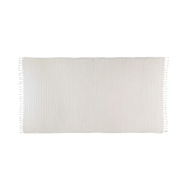 White woven blanket with fringes on a white background