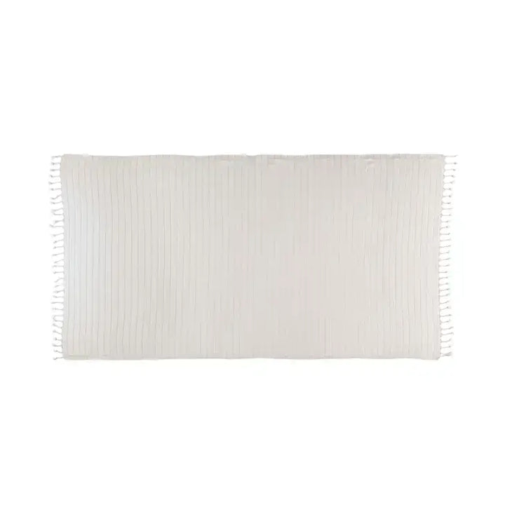 White woven blanket with fringes on a white background