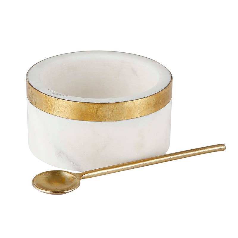 White bowl with gold rim and matching spoon on a white background