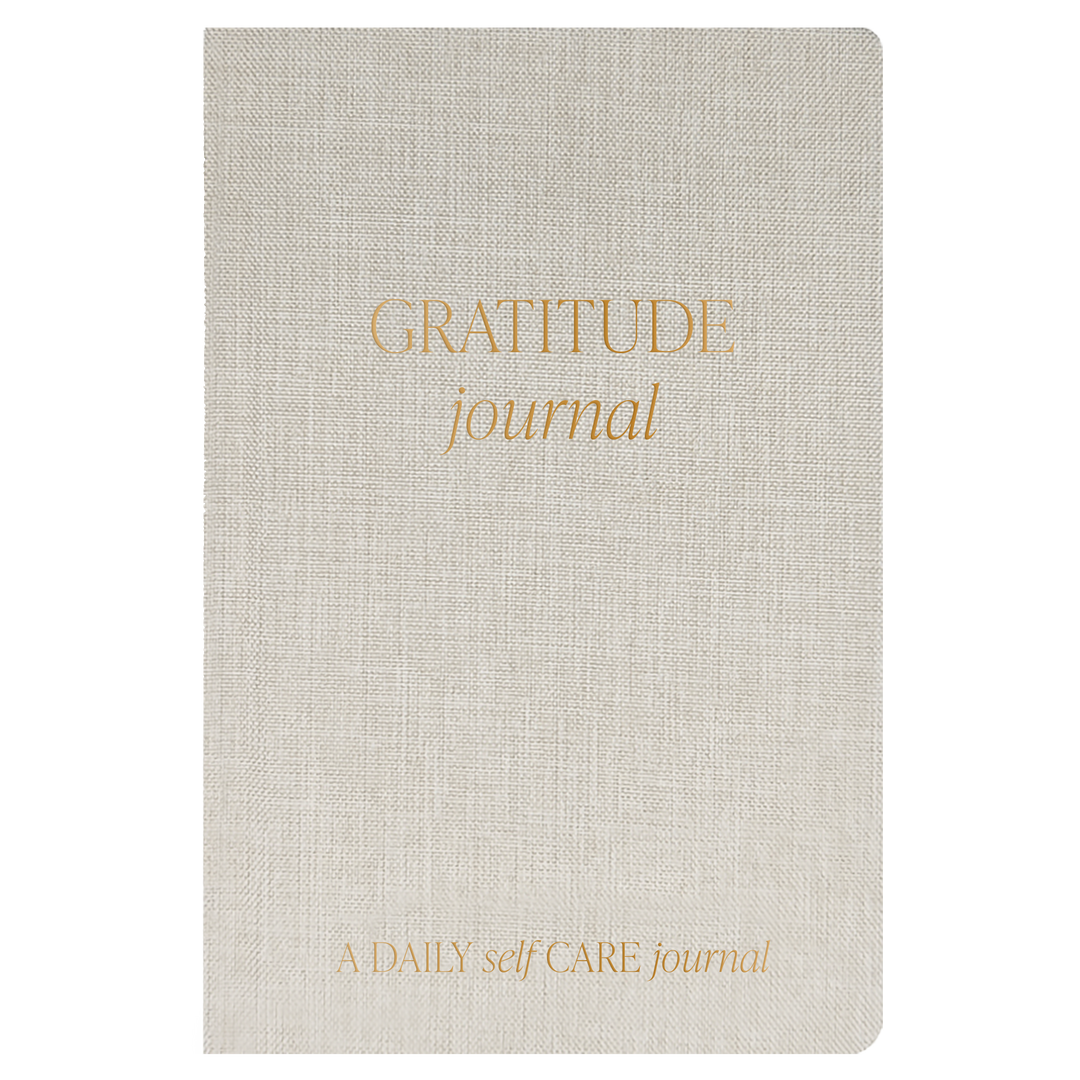 Beige gratitude journal with gold text on a white background