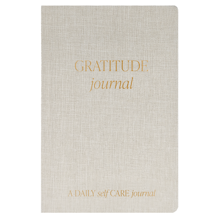 Beige gratitude journal with gold text on a white background